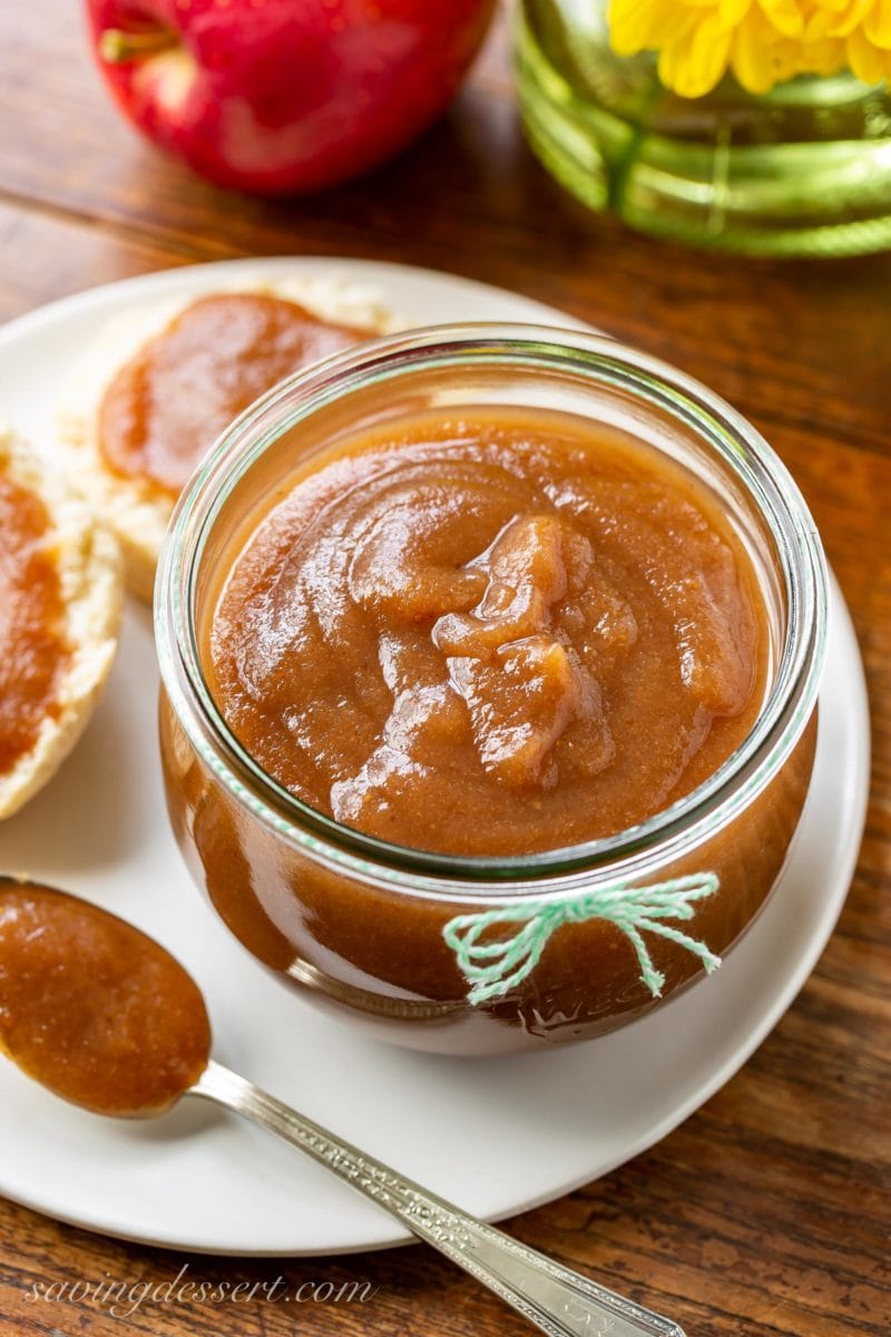 A big jar of maple pear apple butter with biscuits