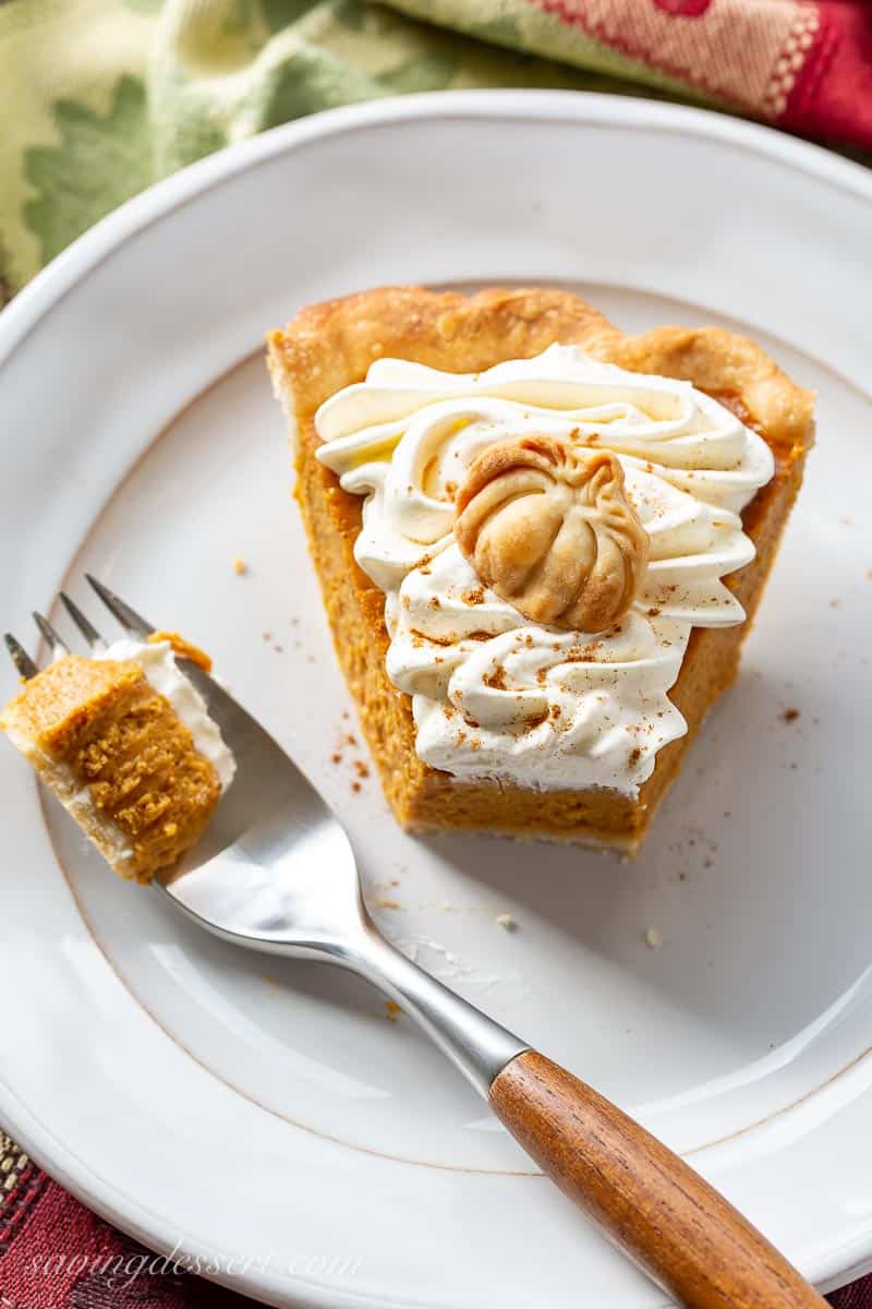 Overhead view of a slice of pumpkin pie with a fork