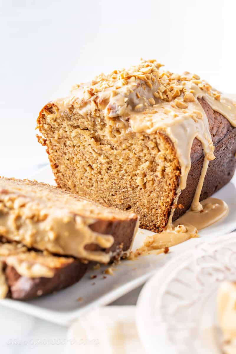a sliced loaf of banana bread with peanut butter icing