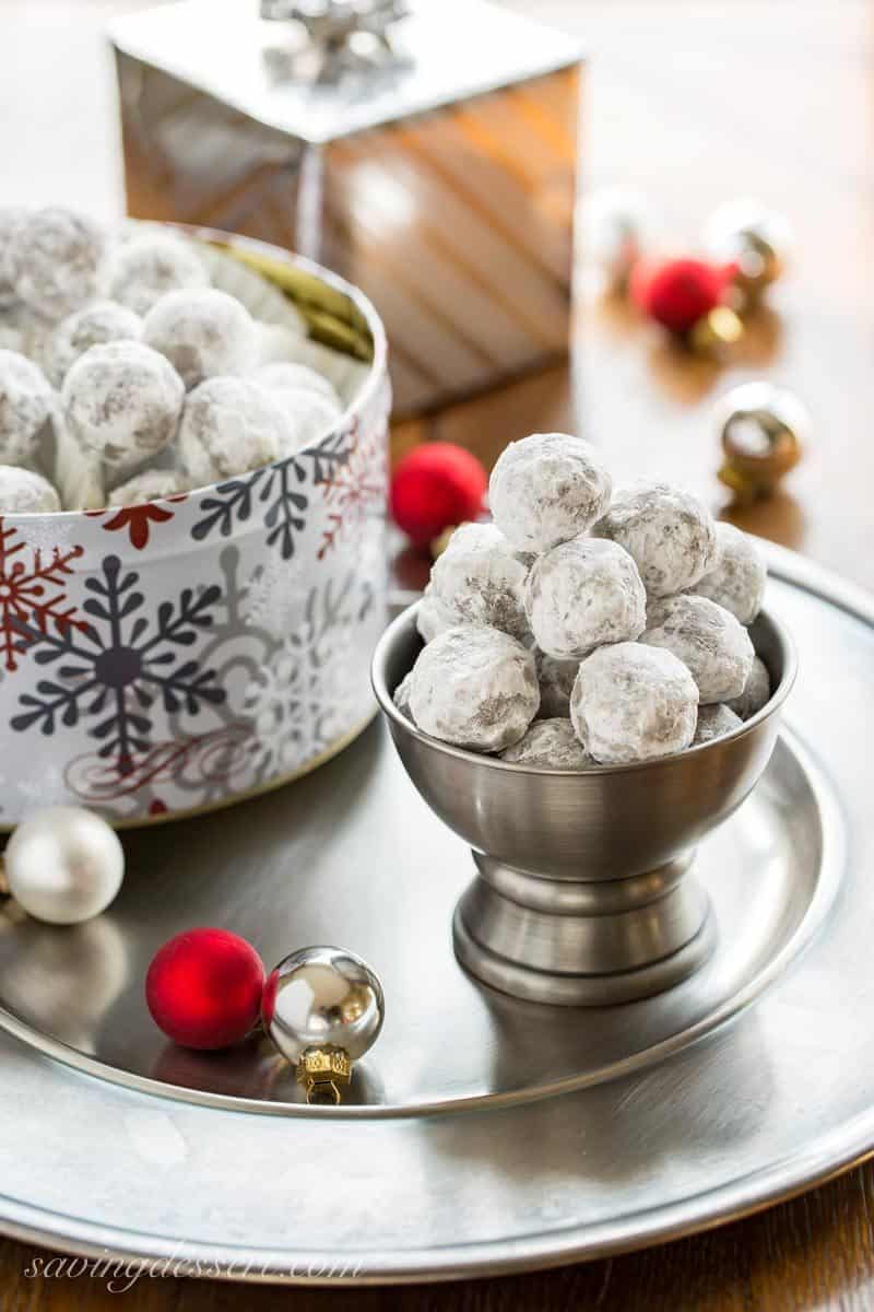 Bourbon Balls ~ an easy no-bake cookie that's been a family favorite for generations. Grab a bottle of your favorite bourbon or rum and mix up these delicious grownup holiday treats. www.savingdessert.com #savingroomfordessert #bourbon #bourbonballs #rumballs #nobakecookies #holidaytreats