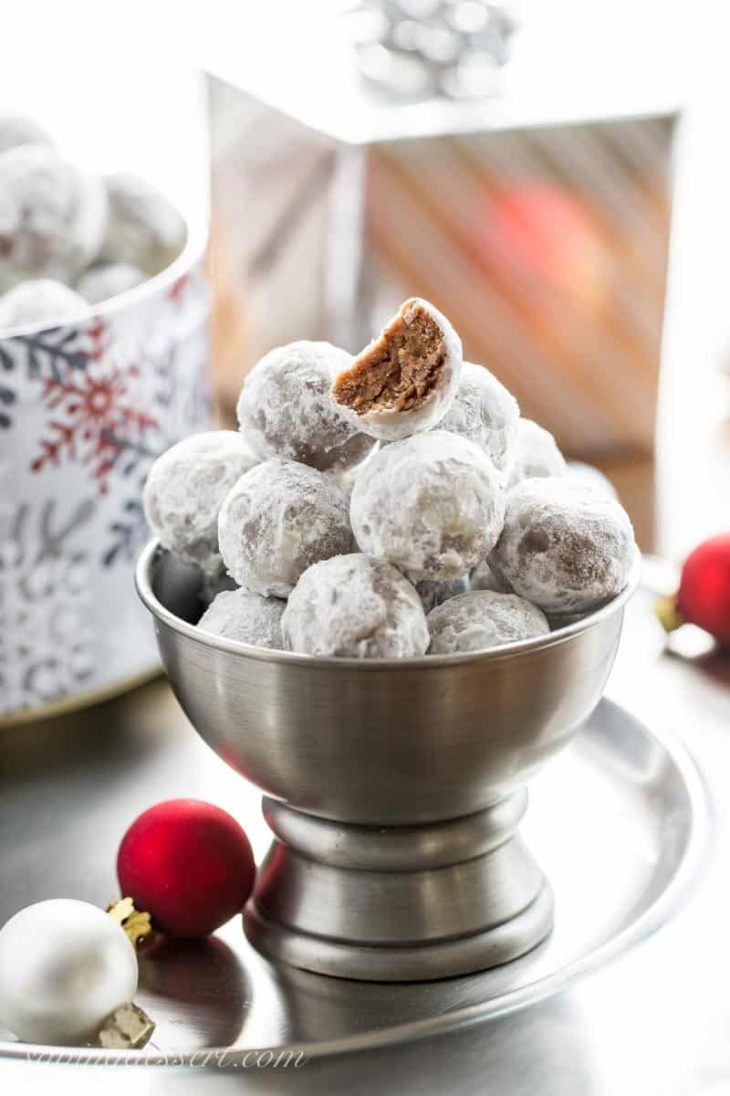 A bowl of no-bake bourbon balls rolled in powdered sugar