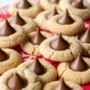 A side view of a pile of peanut butter blossom cookies