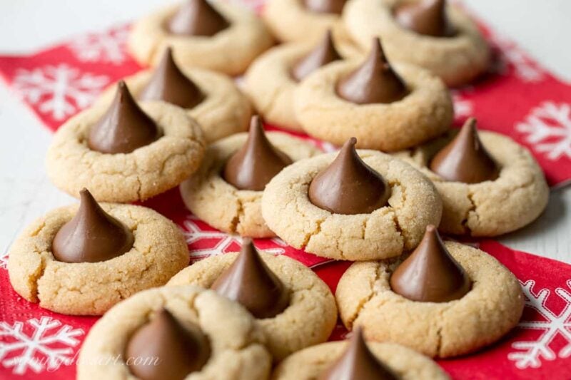 A side view of a pile of peanut butter blossom cookies