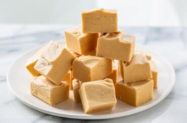 front view of stacked peanut butter fudge on a plate.