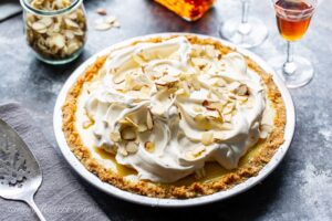 An amaretto cream pie topped with whipped cream and almonds