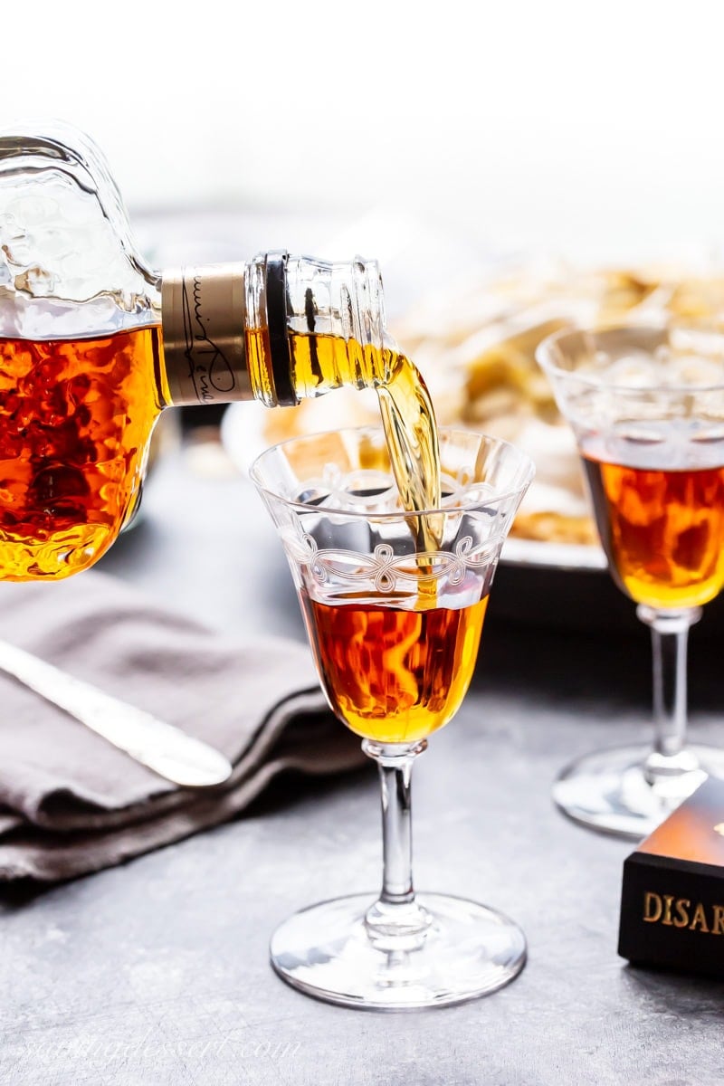 A bottle of amaretto liqueur being poured in a glass