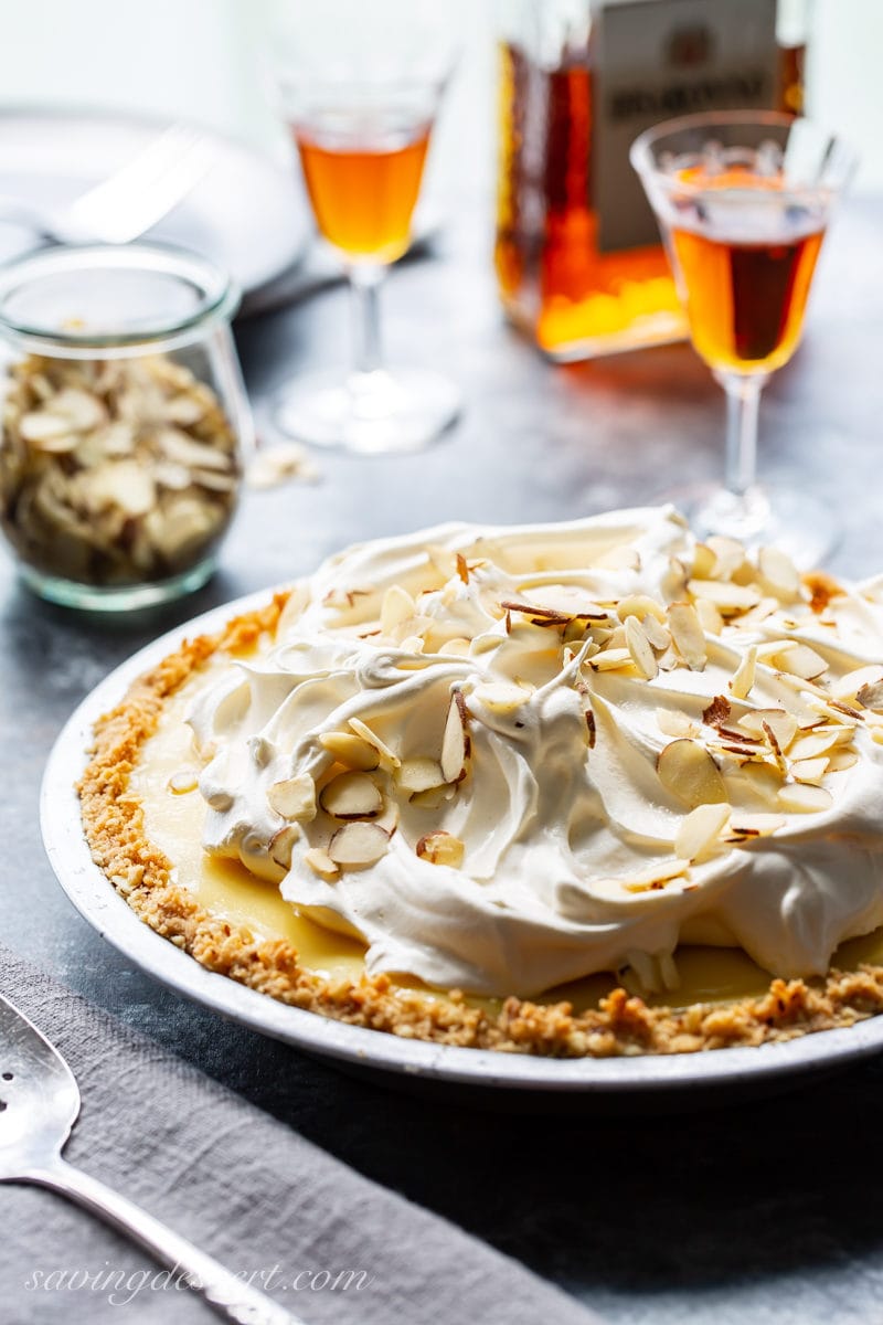 Amaretto Cream Pie topped with whipped cream and almonds served with amaretto liqueur