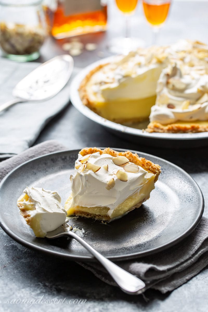 A slice of amaretto cream pie topped with whipped cream and almonds