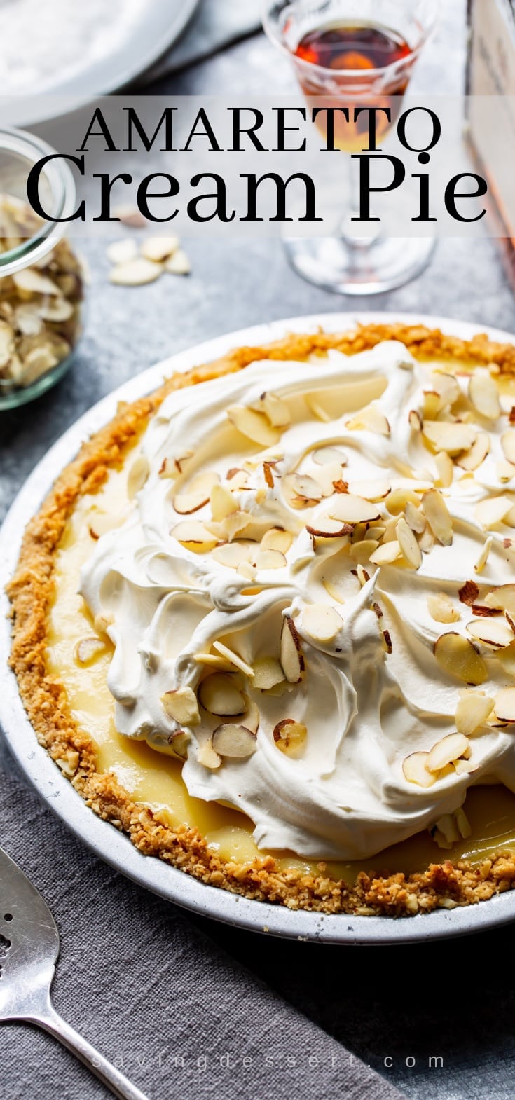 An amaretto cream pie topped with whipped cream and sliced almonds