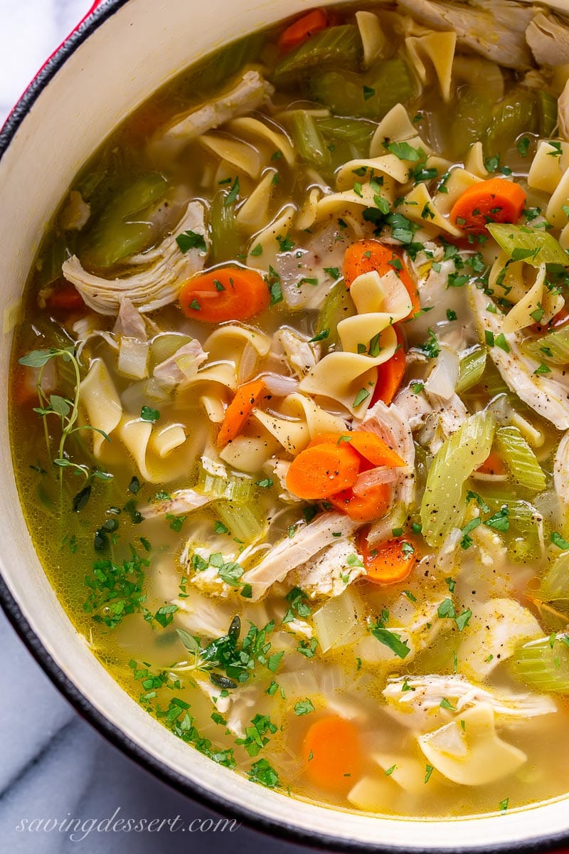 Closeup of a pot of soup with noodles and chicken