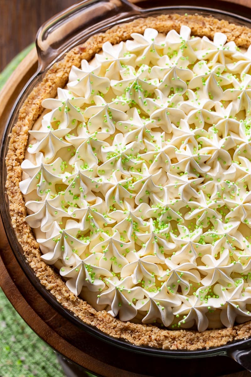 A creamy Irish cream pie topped with whipped cream and green sprinkles