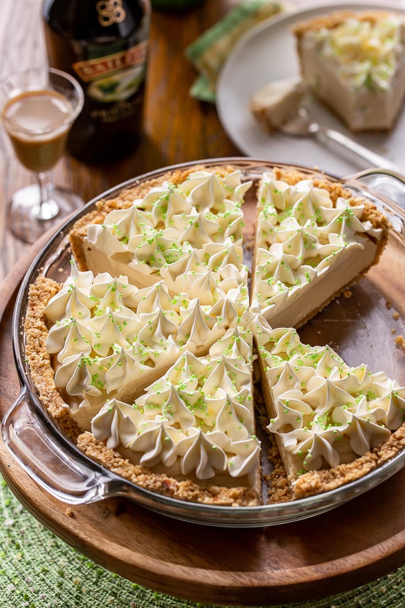 A sliced cream pie decorated with green sprinkles