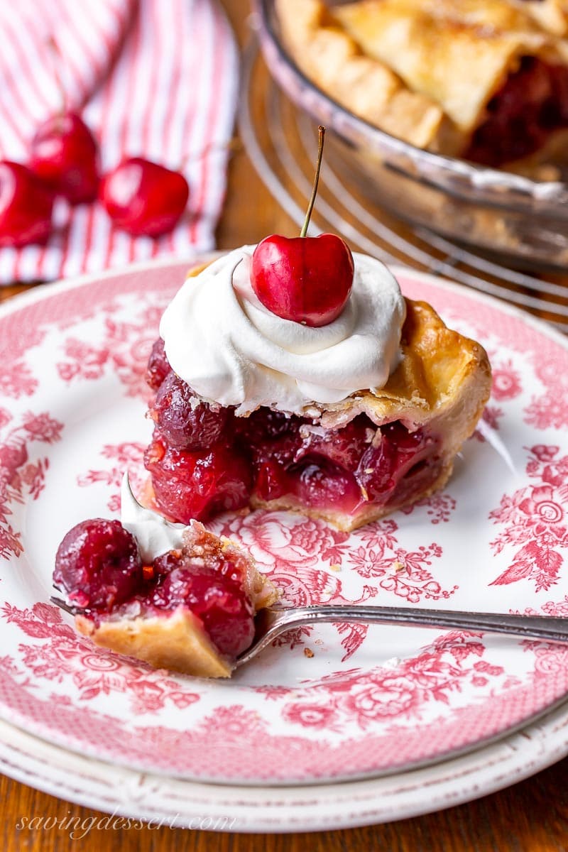 A partially eaten slice of pie with whipped cream on top