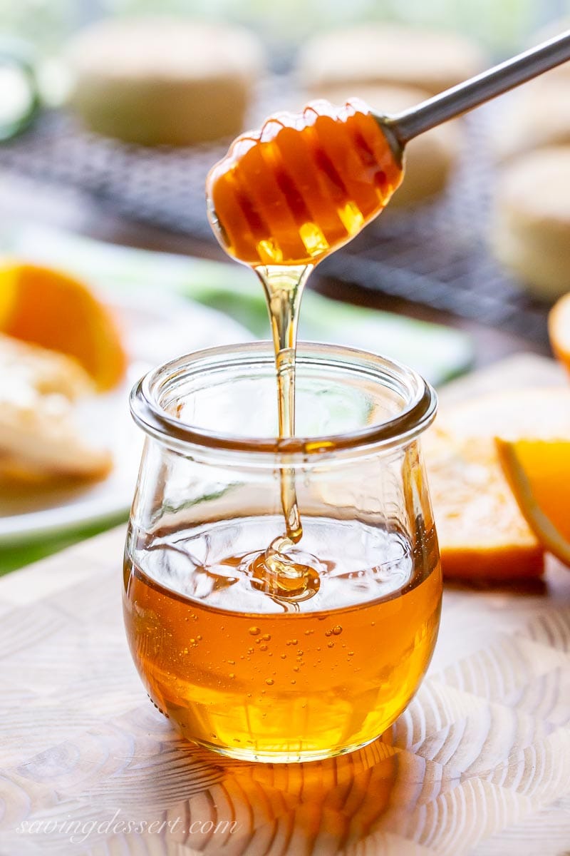 A jar of honey being drizzled