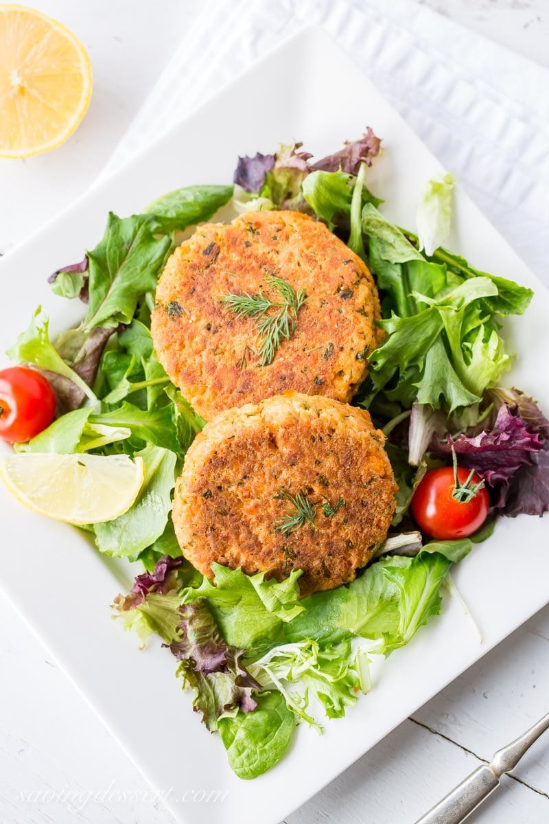 salmon patties served on a salad with fresh dill