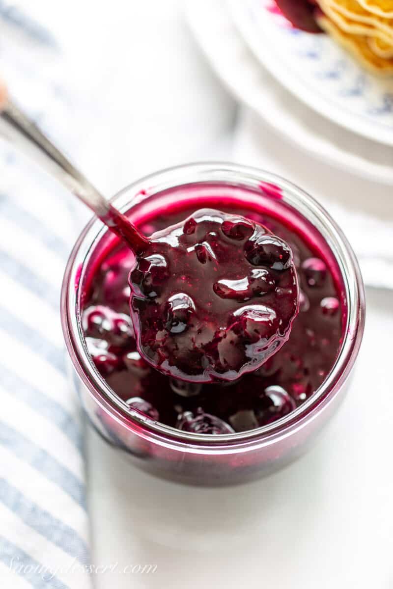 a spoonful of blueberry sauce over a jar