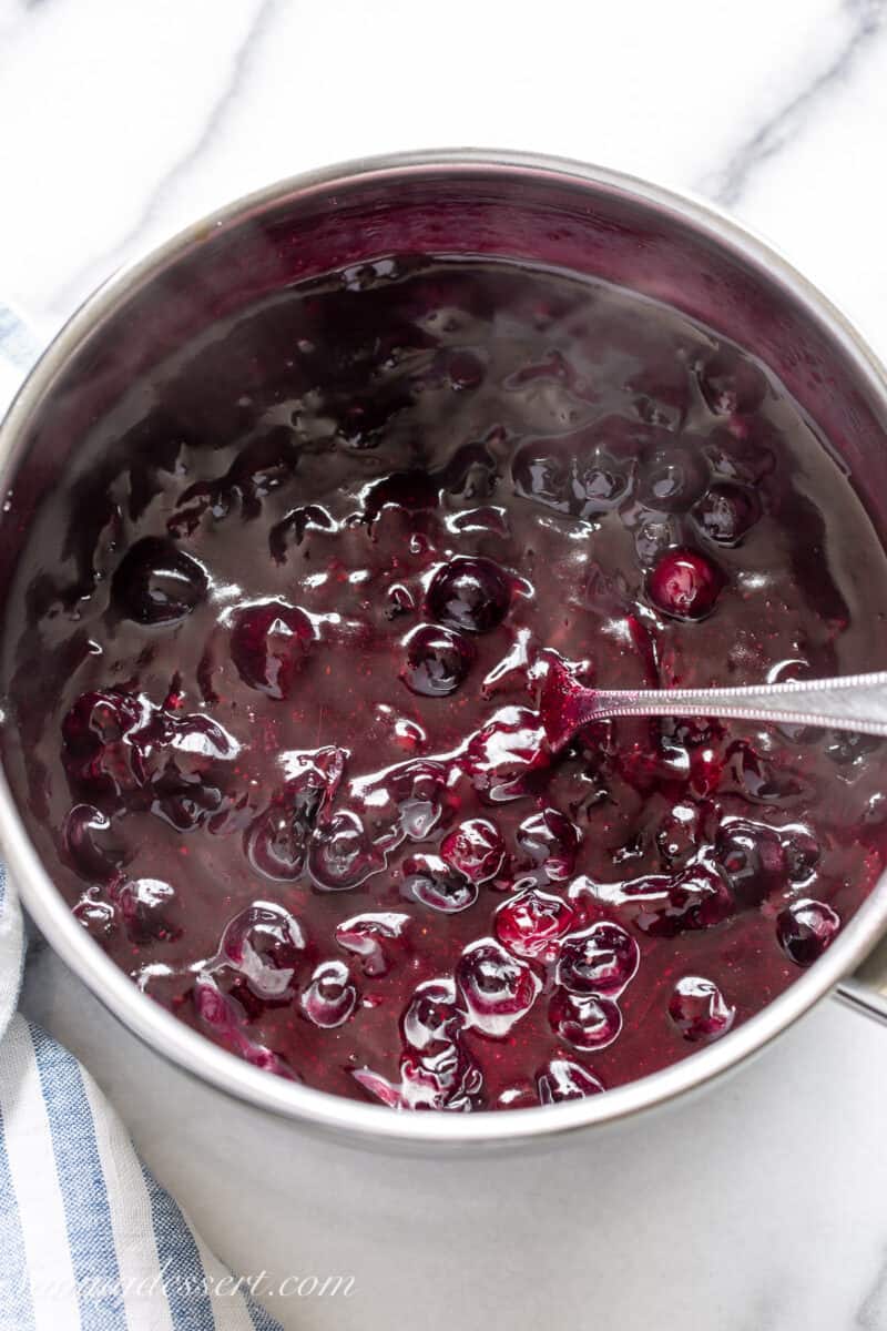 A saucepan filled with hot homemade blueberry sauce