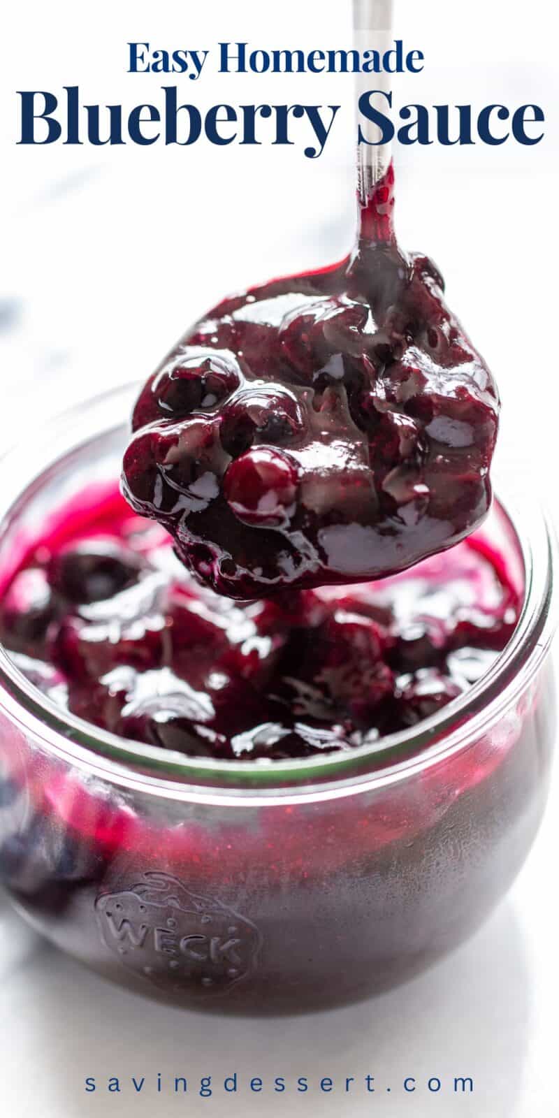 A ladle filled with blueberry sauce being scooped out of a jar