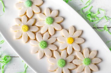 A platter of sugar cookies cut into flower shapes
