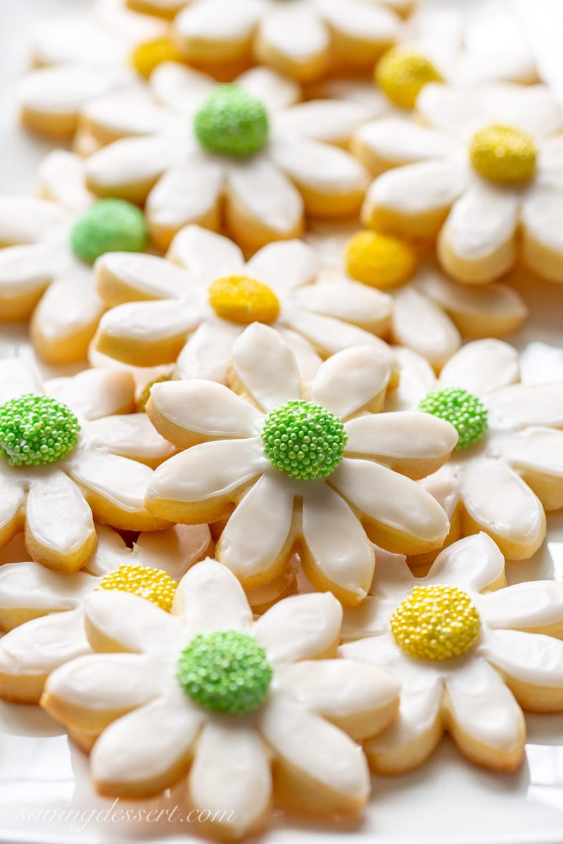 Thick flower shaped cut-out sugar cookies decorated with yellow and green sprinkles