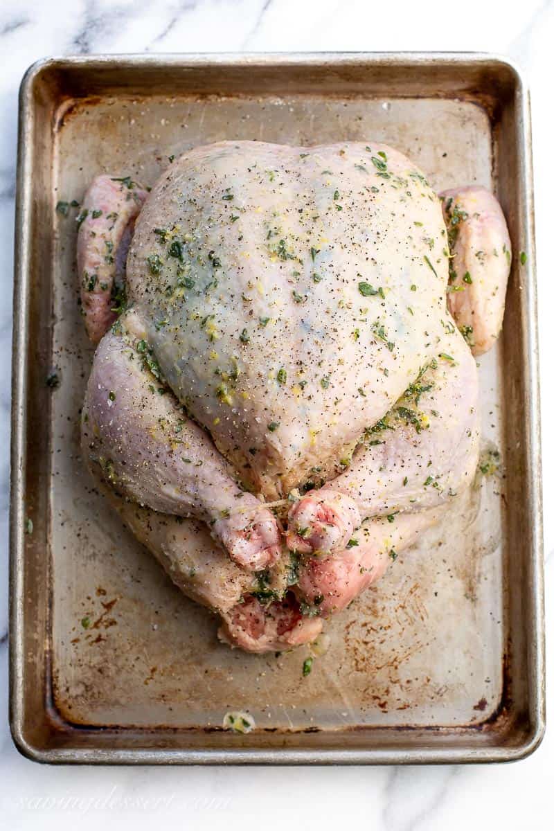 A whole chicken rubbed with herb butter