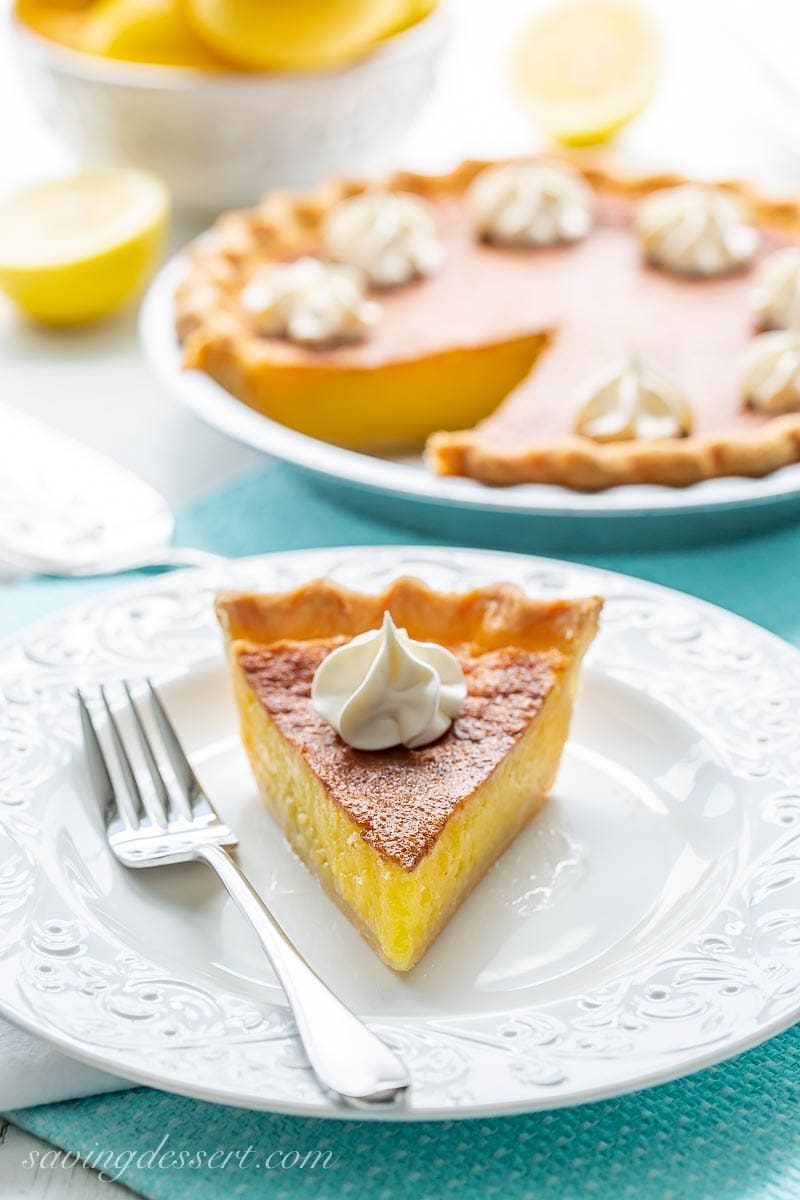 A slice of lemon chess pie with whipped cream on top