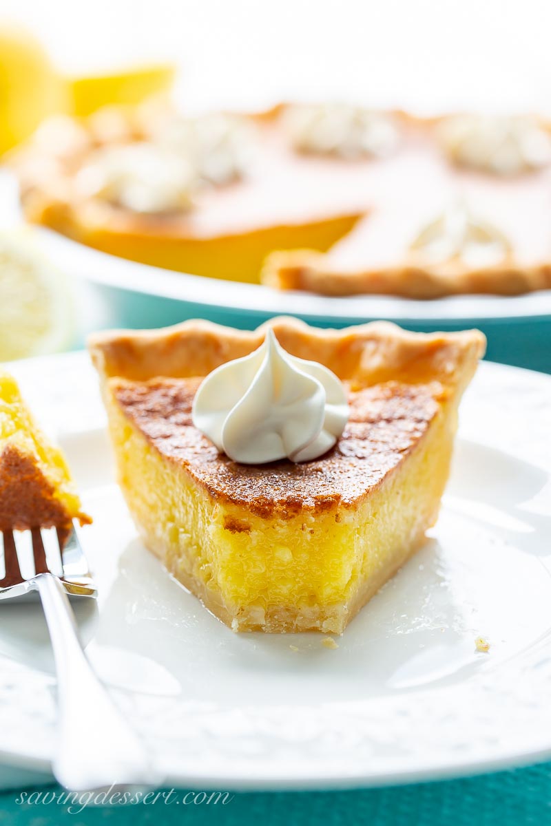 A piece of lemon chess pie with a golden brown top and bright yellow filling