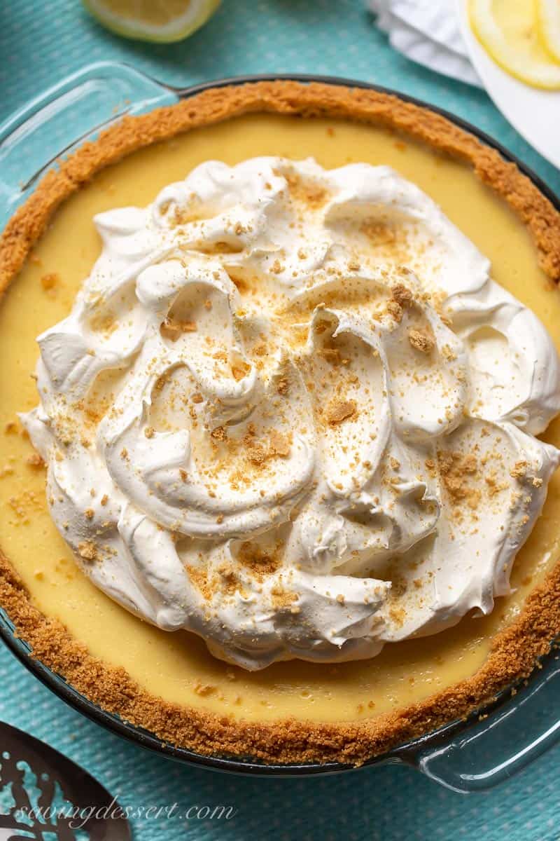 An overhead view of a lemon icebox pie topped with whipped cream swirled with crushed graham crackers