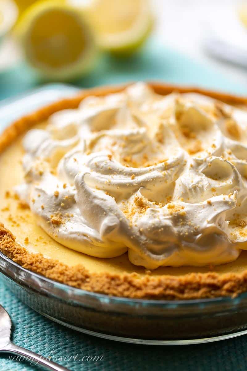 pillowy whipped cream on top of a lemon icebox pie with a graham cracker crust