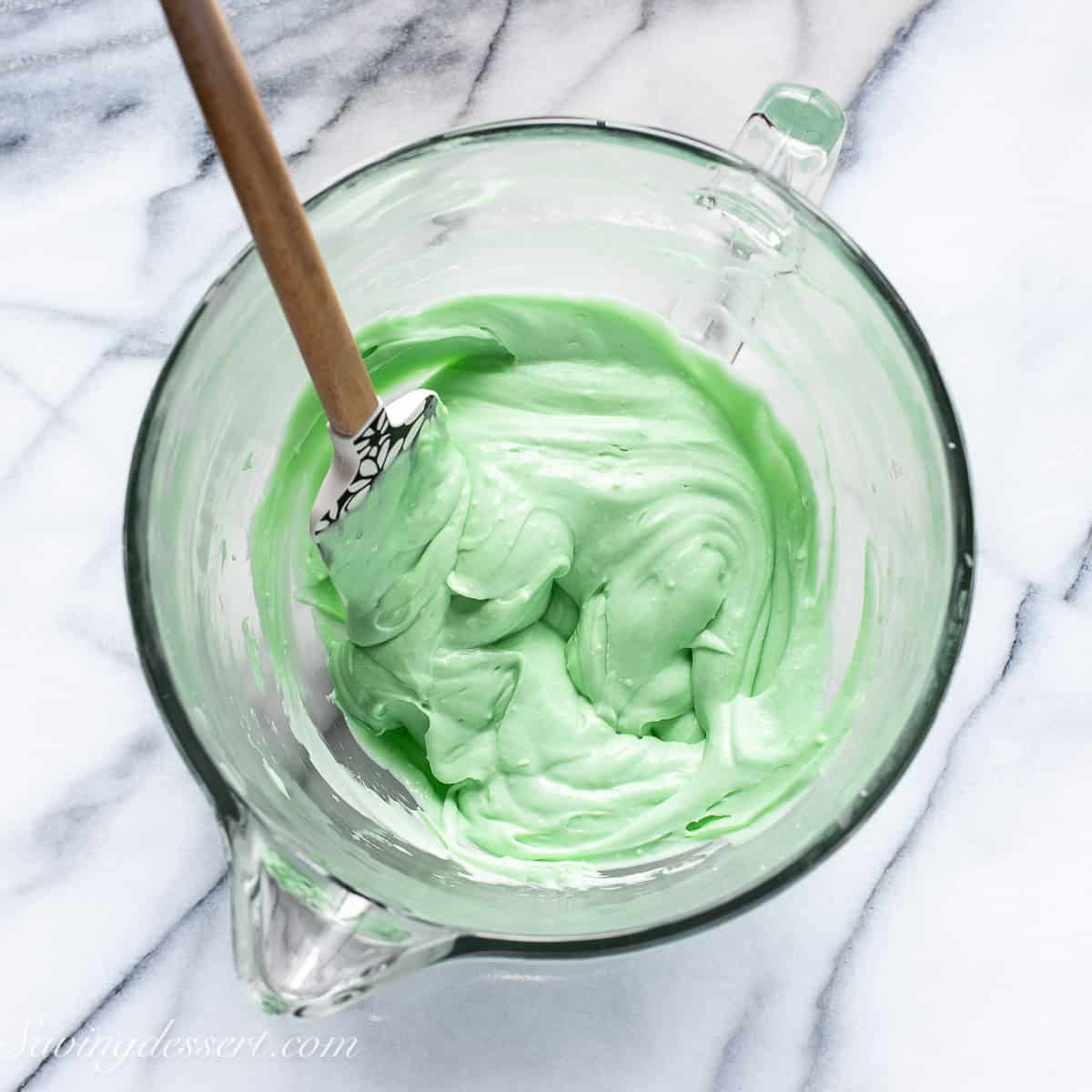 A mixing bowl filled with fluffy green pie filling