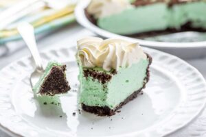 Side view of a slice of Grasshopper Pie with a bite on a fork