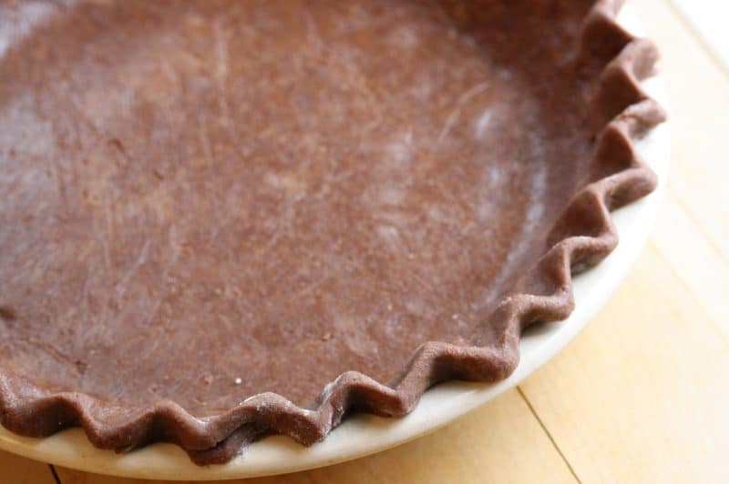 Mississippi Mud Pie - a deliciously light pie with a nice chocolate flavor, crunchy top and soft cake-light middle wrapped up in an easy chocolate crust www.savingdessert.com