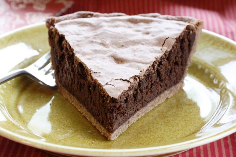 Mississippi Mud Pie - a deliciously light pie with a nice chocolate flavor, crunchy top and soft cake-light middle wrapped up in an easy chocolate crust www.savingdessert.com