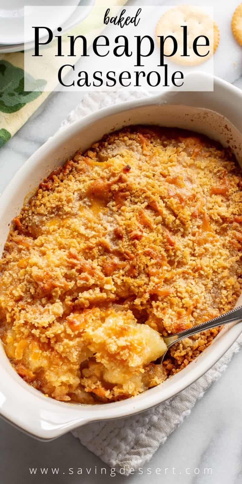 A casserole dish filled with hot baked pineapple casserole with crushed Ritz crackers on top
