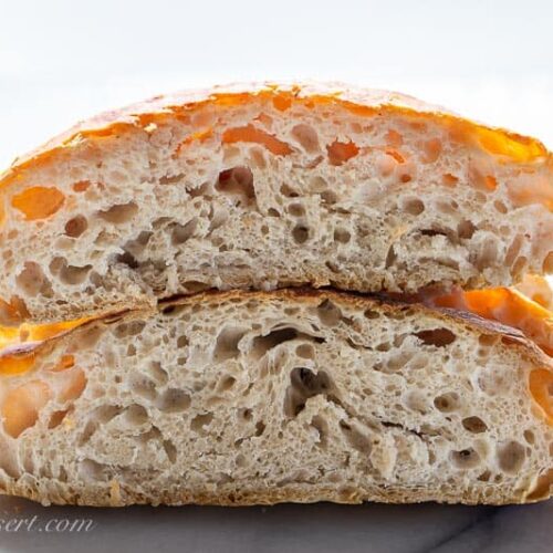 A loaf of artisan bread cut in half and stacked to show the inside of the bread