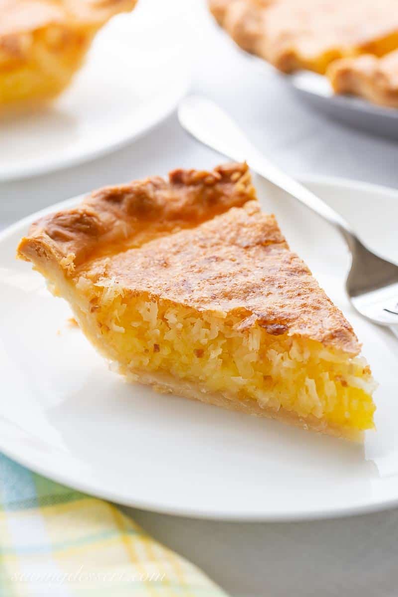 A slice of French coconut pie on a plate with a fork