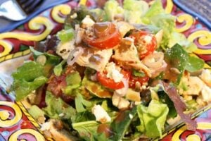 top view of mixed salad with chicken on plate