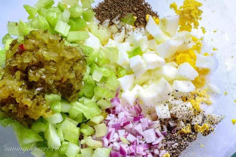 A bowl of relish, celery, eggs, onions and spices