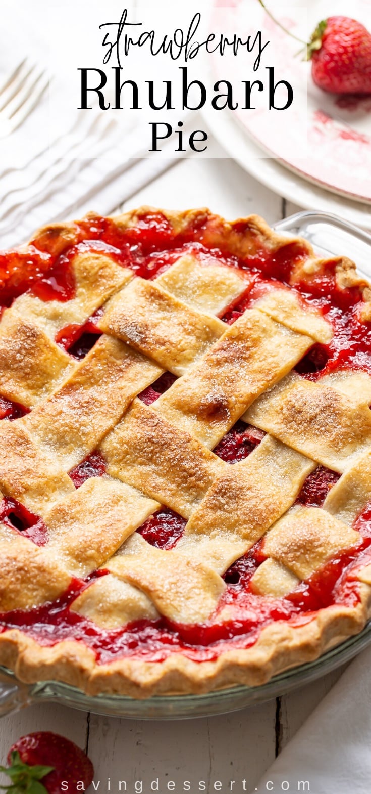 A lattice topped strawberry rhubarb pie with loads of red juices between the crust