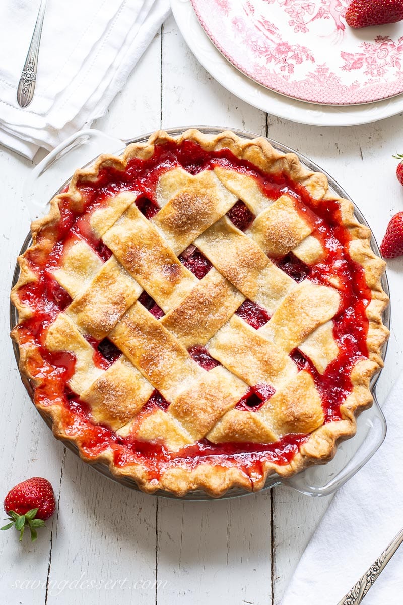 An overhead view of a lattice crust pie with red juices bubbled up around the edges