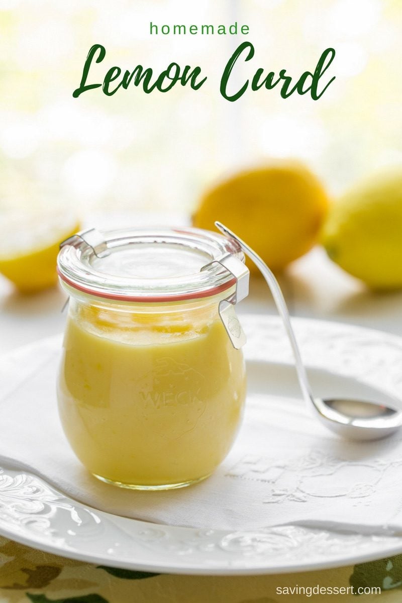 A sealed jar of creamy lemon curd with a spoon