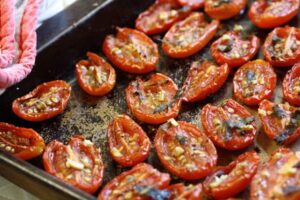 pan of sliced, seasoned and roasted grape tomatoes