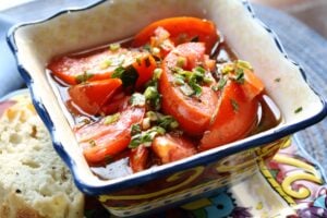 Overhead view of bowl of Marinated Tomatoes.