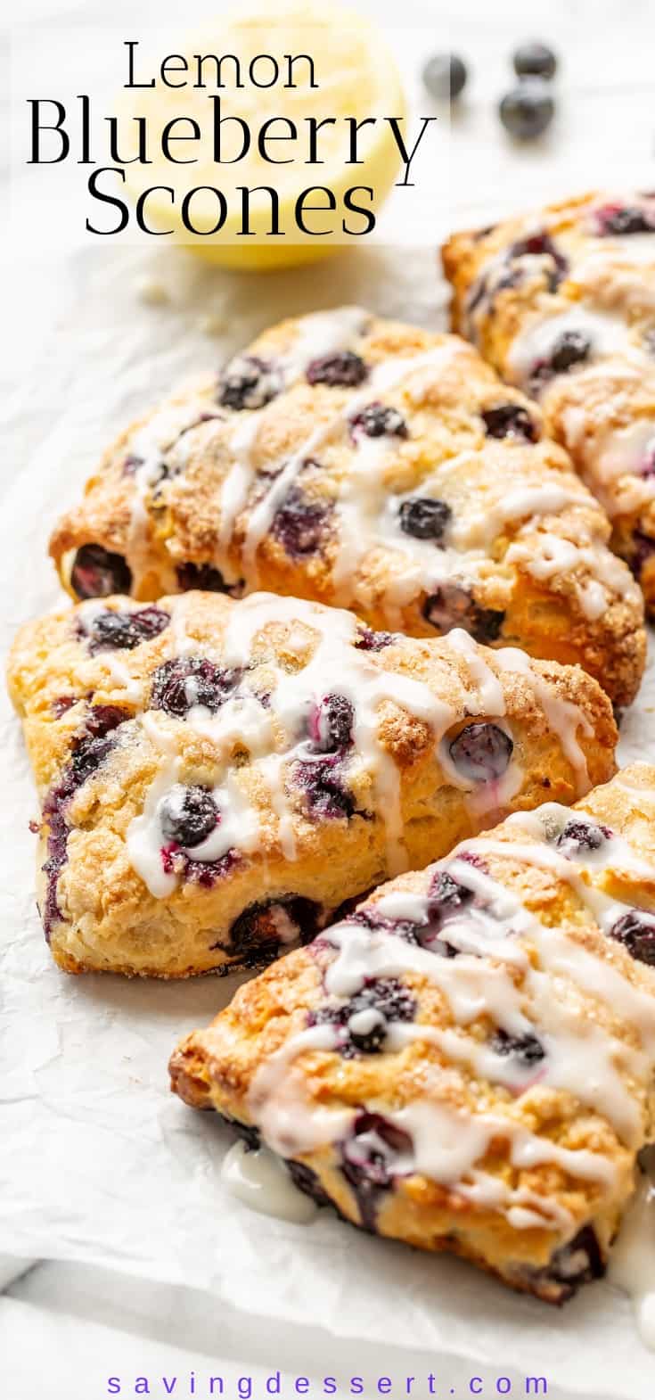 A side view of an array of lemon blueberry scones iced with a lemon drizzle