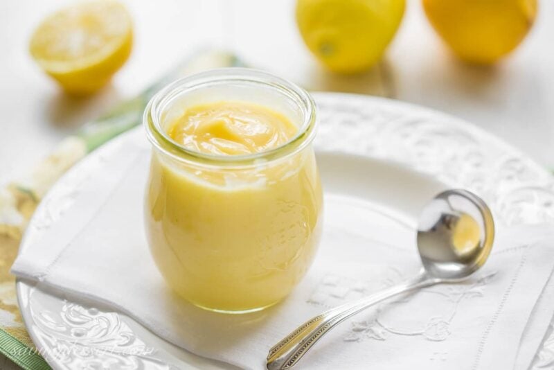 A jar of homemade lemon curd on a plate