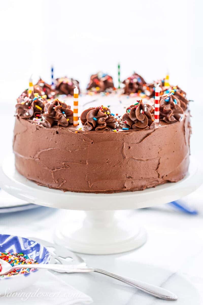 A chocolate cake on a cake stand.