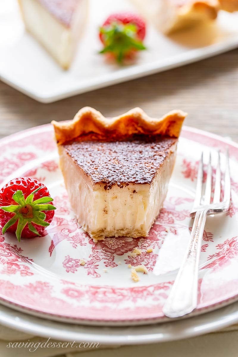 A partially eaten slice of sugar cream pie with a fork