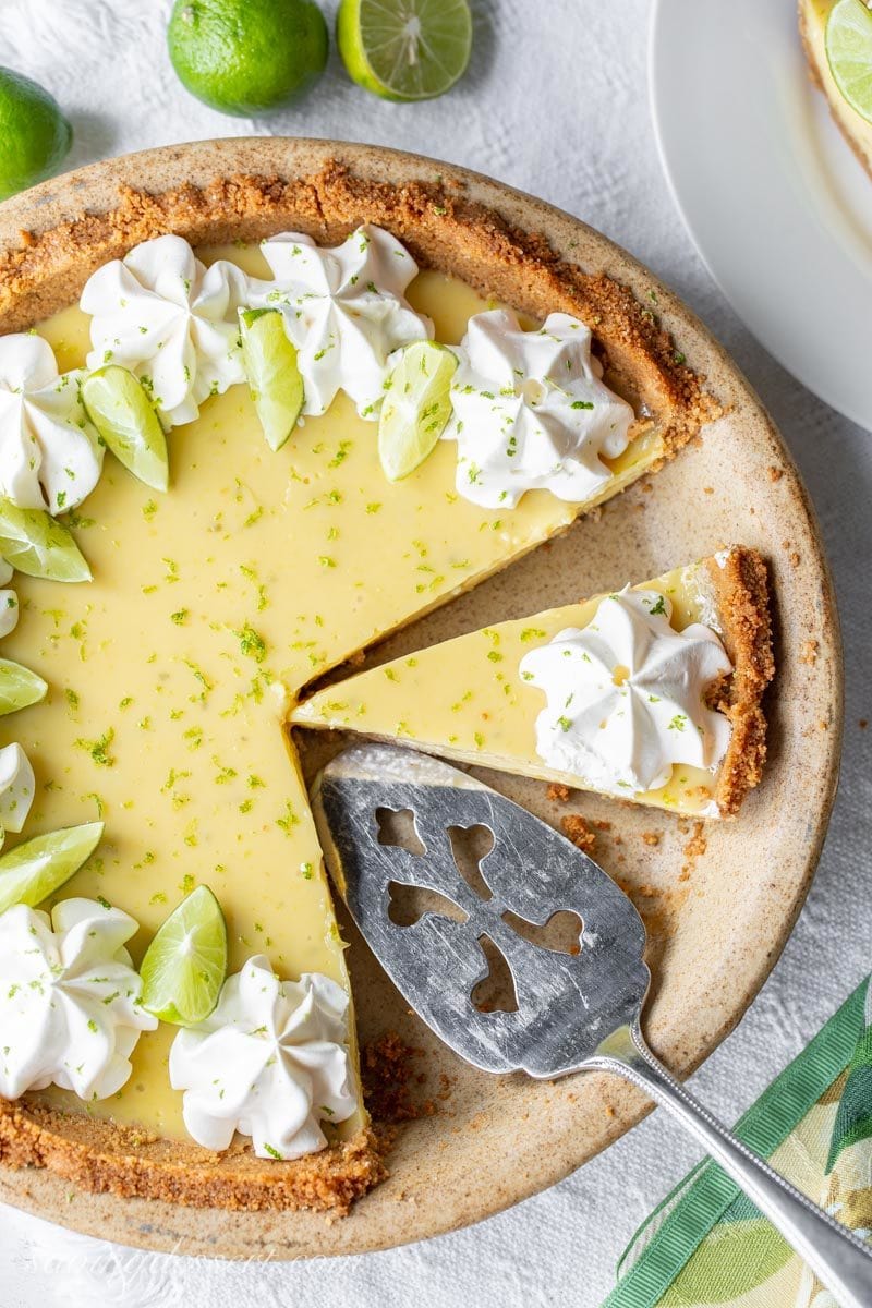 An overhead view of a sliced key lime pie with a pie server