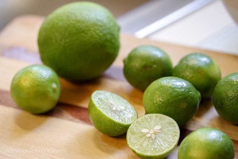 Key Limes and one Persian Lime on a cutting board