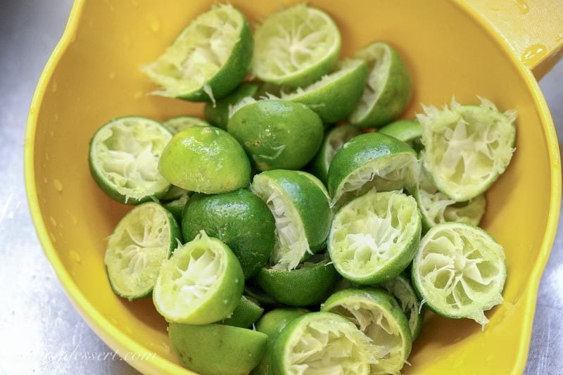 Key limes that have been juiced in a strainer